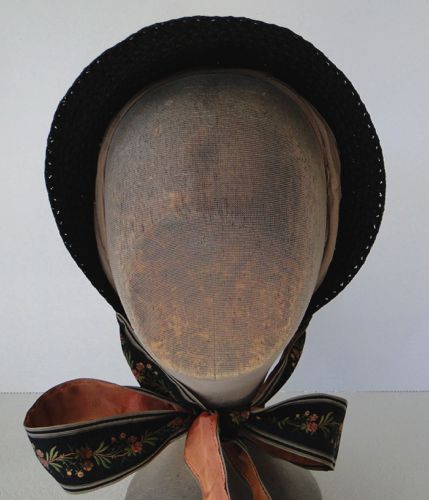 This straw bonnet is in the "Empire" shape that was popular just after the American Civil War.